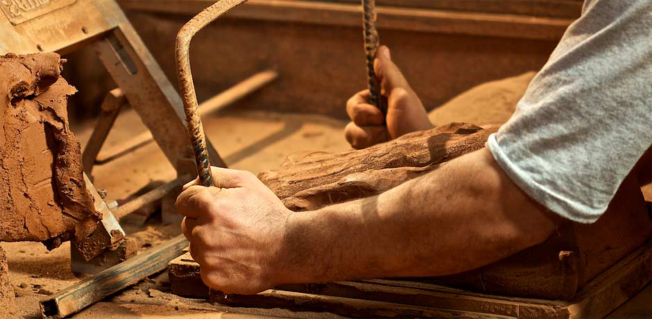 cutting clay on the wooden mould